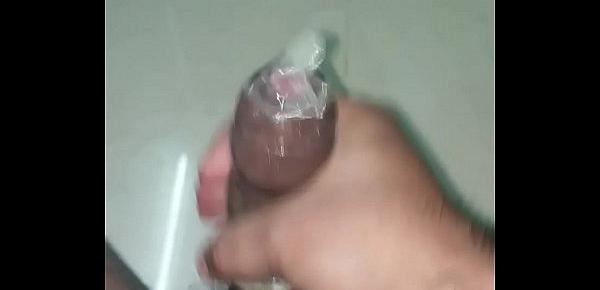  Indian man cums in a dotted condom